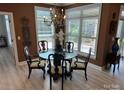 Elegant dining room bathed in natural light, adorned with decorative chandelier and refined table setting at 1330 Millview Ln, Matthews, NC 28104