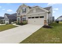 Beautiful two-story home with a two-car garage, stone accents, and a well-maintained lawn at 14116 Glaswick Dr, Charlotte, NC 28278