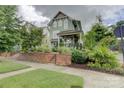 Charming two-story home with a brick facade and beautifully landscaped front yard, situated on a quiet street at 1427 Main St, Charlotte, NC 28204