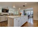 Open-concept kitchen with a large island, granite countertops, and stainless steel appliances flowing into the living area at 1427 Main St, Charlotte, NC 28204