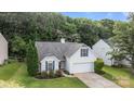 Aerial view of home with mature trees, well-manicured lawn and charming curb appeal at 1445 Deer Forest Dr, Indian Land, SC 29707