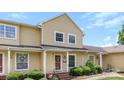 Charming yellow two-story home with well-maintained landscaping and a welcoming front porch at 1670 Robins Nest Ct # C, Gastonia, NC 28054
