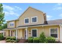Charming yellow two-story home with well-maintained landscaping and a welcoming front porch at 1670 Robins Nest Ct # C, Gastonia, NC 28054