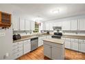 Bright kitchen featuring white cabinets, stainless steel appliances, and a functional center island at 171 Highland Woods Ct, Denver, NC 28037