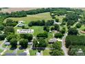 Aerial view of property with surrounding neighborhood, green fields, and mature trees at 1787 Eastover Dr, Mount Pleasant, NC 28124