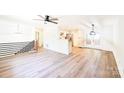 Open-concept living area with hardwood floors, modern railing, and abundant natural light at 1810 Highway 55 W Hwy, Clover, SC 29710