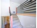 Carpeted stairs with modern railing lead to the upper level, offering a stylish transition between floors at 1810 Highway 55 W Hwy, Clover, SC 29710