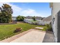 Spacious backyard with a well-maintained lawn, mature trees, and a charming fire pit at 1901 Summit Ridge Ln, Kannapolis, NC 28083