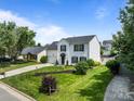 Charming two-story home with white siding, manicured lawn, and attractive landscaping at 1901 Summit Ridge Ln, Kannapolis, NC 28083