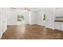 Bright living room featuring wood floors and white walls, flooded with natural light at 2005 Amos Oaks Ln, Charlotte, NC 28215