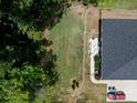 Aerial view of the property, showcasing the backyard patio with outdoor seating and landscaped garden beds at 203 Poplins Grove Church Rd, Albemarle, NC 28001