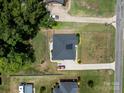 Aerial view of the property featuring a well-maintained lawn, landscaping, and a paved driveway at 203 Poplins Grove Church Rd, Albemarle, NC 28001