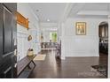 Bright foyer with dark wood floors, bench seating, and views of the dining room at 205 Church St, McAdenville, NC 28101