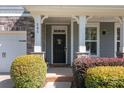 Inviting front entrance with stone accents, decorative plants, and charming details at 205 Church St, McAdenville, NC 28101