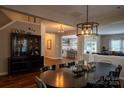 Open dining room with hardwood floors, stylish light fixture, and view to the kitchen at 2090 Durand Rd, Fort Mill, SC 29715