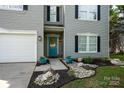 Inviting front exterior with a teal door, black shutters, and landscaped yard at 2090 Durand Rd, Fort Mill, SC 29715