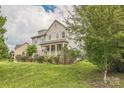 Attractive two-story home featuring a classic front porch and well-maintained lawn at 2100 Darian Way, Waxhaw, NC 28173
