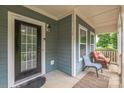 Inviting front porch with seating area, classic door, and ample natural light at 2100 Darian Way, Waxhaw, NC 28173