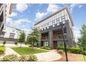 Modern brick townhome with a well-manicured lawn and sidewalk in a community setting at 2523 Irwin Stream Rd, Charlotte, NC 28208