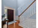 Welcoming entryway featuring hardwood floors, a staircase, and a beautiful wooden front door at 3006 S Legacy Park Blvd, Indian Land, SC 29707