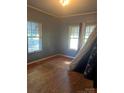 Bright bedroom with hardwood floors and ample natural light, offering a tranquil retreat at 3220 Harmony Hwy, Harmony, NC 28634