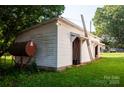 An outbuilding includes several bays with a ladder and a visible oil tank at 3220 Harmony Hwy, Harmony, NC 28634