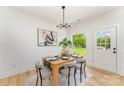 Bright dining area with modern chandelier, table with four chairs and view of landscaped backyard at 3486 Winters St, Newton, NC 28658