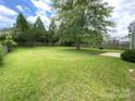 Expansive backyard featuring mature trees and a well-maintained lawn at 3933 Cameron Creek Dr, Matthews, NC 28105