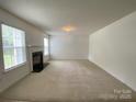 Bright living room featuring a fireplace and ample space for entertaining at 3933 Cameron Creek Dr, Matthews, NC 28105