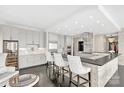 A stylish and expansive kitchen with bar seating and sleek stainless steel appliances at 435 S Tryon St, Charlotte, NC 28202