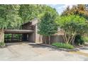 Exterior daytime view showing covered parking with mature trees and the address number 4725 on the building at 4725 Rounding Run Rd, Charlotte, NC 28277