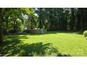 Spacious backyard featuring an above-ground pool with ladder and large lawn at 5832 Thompson Rd, Charlotte, NC 28216