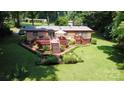 A beautiful backyard features a deck, manicured lawn, and garden at 5832 Thompson Rd, Charlotte, NC 28216