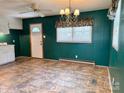 Dining room with vinyl floor, and a window featuring a floral valance at 613 Catawba St, Chester, SC 29706