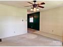 Spacious living room with carpet, a ceiling fan, and a glimpse into the adjacent dining area at 613 Catawba St, Chester, SC 29706