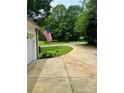 Long driveway leading to a well-maintained property with lush greenery at 613 Stacy Ridge Rd, Gastonia, NC 28052