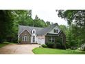 Brick home with dormer windows, attached garage, and pristine lawn at 613 Stacy Ridge Rd, Gastonia, NC 28052