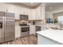 Modern kitchen with stainless steel appliances, white cabinets, and quartz countertops at 739 Elders Story Rd, Fort Mill, SC 29708