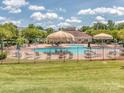 Community pool area with lounge chairs, umbrellas, and a clubhouse at 739 Elders Story Rd, Fort Mill, SC 29708