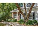 Charming home with brick facade, inviting entrance, and lush landscaping provides pleasant curb appeal at 10105 Reindeer Way Ln, Charlotte, NC 28216