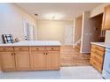 Open concept kitchen with an island, wood cabinets, and new floors at 10105 Reindeer Way Ln, Charlotte, NC 28216