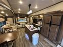 Open RV interior featuring island kitchen, living area, and modern appliances at 104 Cardinal Dr, New London, NC 28127