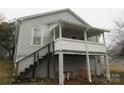 A home featuring a white, elevated porch and stairs to a partial basement at 1110 20Th Ne St, Hickory, NC 28601