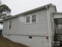 A home featuring vinyl siding, windows, and a partial basement at 1110 20Th Ne St, Hickory, NC 28601