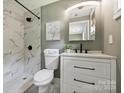 Updated bathroom with marble shower, modern vanity, and sleek black fixtures at 11539 Five Cedars Rd, Charlotte, NC 28226