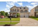 Charming two-story home with a well-manicured lawn and a three-car garage at 124 Glade Valley Ave, Mooresville, NC 28117