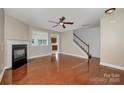Spacious living room with hardwood floors, fireplace, and an open staircase at 124 Glade Valley Ave, Mooresville, NC 28117