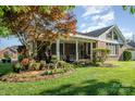 Well-manicured backyard featuring a covered patio, flower beds, and lush lawn at 1610 Union Rd # 1610B, Gastonia, NC 28054