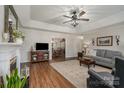 Inviting living room boasts hardwood floors, tray ceiling, fireplace, and open layout to the dining room at 1610 Union Rd # 1610B, Gastonia, NC 28054