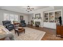 Comfortable living room featuring a fireplace, built-in shelving, hardwood floors, and ample natural light at 1610 Union Rd # 1610B, Gastonia, NC 28054